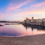 Panoramic view of Antibes on sunset from Plage de la Gravette, French Riviera, France